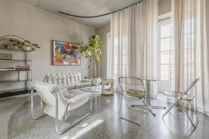a living room with a glass table and chairs at SCALA by Valletta Vintage in Valletta