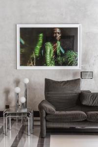 a living room with a couch and a picture on the wall at SCALA by Valletta Vintage in Valletta
