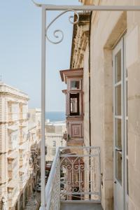 a balcony with a view of a city at SCALA by Valletta Vintage in Valletta
