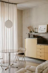 a living room with a glass table and a couch at SCALA by Valletta Vintage in Valletta