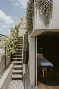 a staircase leading up to a bedroom on a balcony at SCALA by Valletta Vintage in Valletta