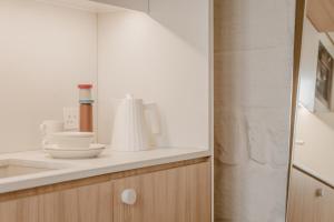 a bathroom with a sink and a shower at SCALA by Valletta Vintage in Valletta