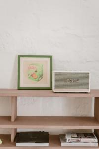 a shelf with a picture and a radio on it at SCALA by Valletta Vintage in Valletta