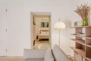 a living room with a couch and a mirror at SCALA by Valletta Vintage in Valletta