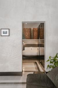 a living room with a couch and a bed at SCALA by Valletta Vintage in Valletta
