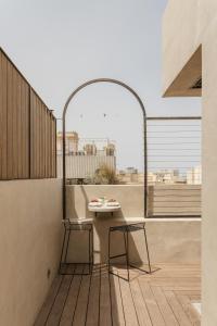 a patio with a table and two chairs on a balcony at SCALA by Valletta Vintage in Valletta