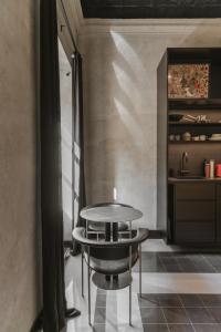 a table and chairs in a room with a shelf at SCALA by Valletta Vintage in Valletta