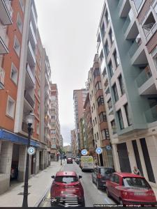 a city street with cars parked on the street at Apartamento Ángela in Gijón