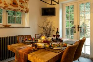 a wooden table with food and wine glasses on it at Flurry's Lodge in Coleford