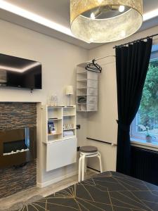 a bedroom with a fireplace and a bed and a window at Studio Belaj in Celje