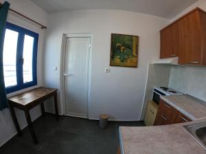 a kitchen with a sink and a table and a window at AGIAS PELAGIAS LITTLE BEACH HOUSE in Agia Pelagia Kythira +18 photos