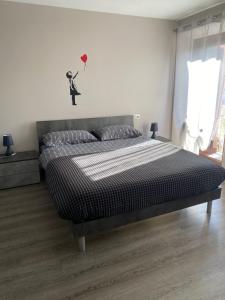 a bedroom with a bed with a black and white comforter at Casa Vacanze Spolina Cossato BI in Cossato