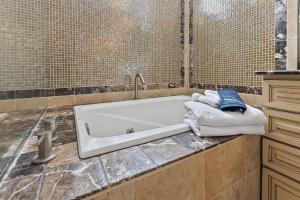 a bathroom with a tub with towels on a counter at Oceanview Family & Pet-Friendly Escape, 300 Steps to Beach, 2608H in New Smyrna Beach +53 photos