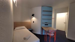 Postel nebo postele na pokoji v ubytování Appart'Hôtel Lauréades Clermont-Ferrand Centre Jaude