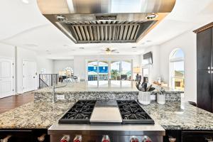 a kitchen with a stove top oven in a room at Oceanview Family & Pet-Friendly Escape, 300 Steps to Beach, 2608H in New Smyrna Beach