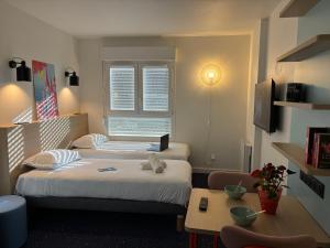 Postel nebo postele na pokoji v ubytování Appart'Hôtel Lauréades Clermont-Ferrand Centre Jaude