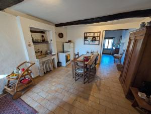 a kitchen and dining room with a table and chairs at Cuore del Castello in Arrone