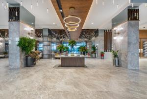 a lobby with a reception area with potted plants at Sural Saray Hotel in Side +42 photos