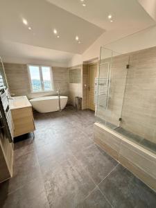 a large bathroom with a tub and a shower at Magnifique Studio Cagnes Sur Mer in Cagnes-sur-Mer