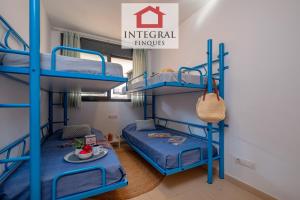a bedroom with bunk beds in a hostel at Apartament Cel Blau in Palamós +15 photos