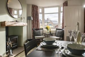 a dining room with a table and a mirror at California Cottage in Barnard Castle