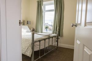 a bedroom with a bed and a window at California Cottage in Barnard Castle