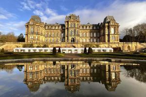 an old building with its reflection in the water at California Cottage in Barnard Castle