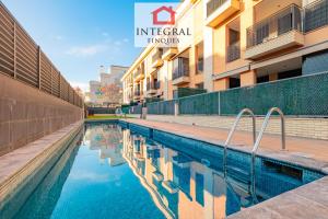 a swimming pool in front of a building at Apartament Cel Blau in Palamós