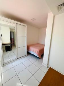 a bedroom with a bed and a mirror at Hospedaria Catete in Rio de Janeiro