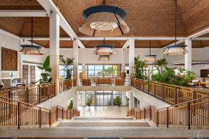 a large lobby with stairs and potted plants at Grande Real Santa Eulalia Resort & Hotel Spa in Albufeira