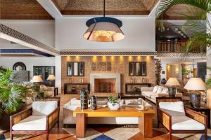 a living room filled with furniture and a fireplace at Grande Real Santa Eulalia Resort & Hotel Spa in Albufeira