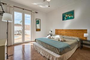 a bedroom with a bed and a sliding glass door at Villa Martin in Portocolom +34 photos