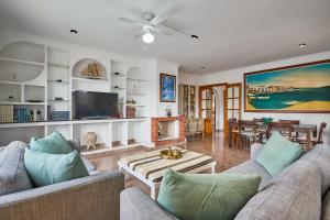 a living room with two couches and a tv at Villa Martin in Portocolom