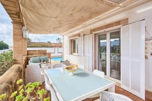 a room with a table and chairs on a patio at Villa Martin in Portocolom