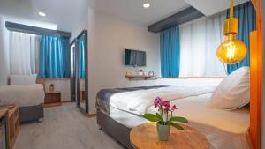 a bedroom with a large bed and a table with flowers at The Gate Kadıköy Downtown in Istanbul +83 photos