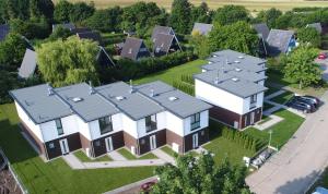 an overhead view of a house with solar panels on it at Baltic Village - VIP Haus in Damp