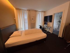 a hotel room with a bed and a desk at Apart Hotel Fulda in Fulda