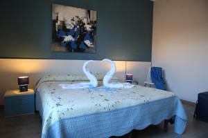 a bedroom with a bed with a swan sculpture on it at Le 3 B in Catania