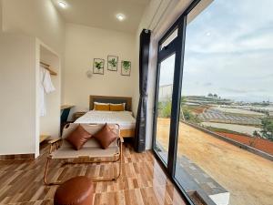 a bedroom with a bed and a large window at Villa Healing Home - Hồ Bơi Nước Nóng in Trai Mat