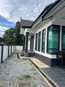 a white house with a pathway leading to it at Syakila Homestay in Marang +5 photos