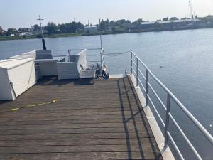 a dock with a boat on the water at HausboootHL in Lübeck