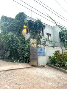 a building with a wooden door in front at Lush Urbarn Oasis in Kampala