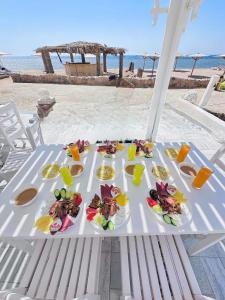 a table with plates of food on the beach at Nubia Island View Dahab in Dahab