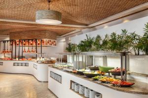 a buffet line with a lot of food at Grande Real Santa Eulalia Resort & Hotel Spa in Albufeira