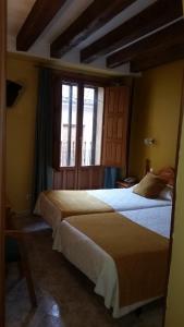 
a bedroom with a bed and a window at San Miguel in Segovia
