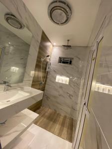 a bathroom with a shower and a sink at Peacock Studio Tiny House in Kuala Terengganu +5 photos