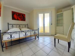 a bedroom with a bed and a chair at Maria in Caleri +7 photos