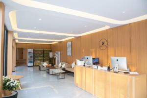 a lobby with a library with tables and chairs at Ruby Hotel in Vientiane