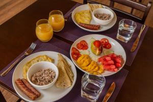 a table with three plates of breakfast food on it at Pearl Dhigurah in Dhigurah