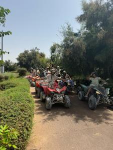 a group of people riding atvs on a dirt road at Grand appartement fabuleux in Agadir